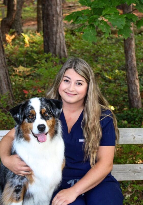 A woman and her dog posing for the camera.